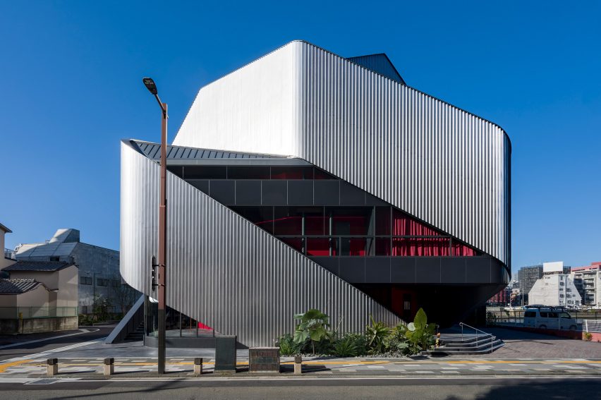 Exterior of a theatre building with sweeping steel panels by Clouds AO