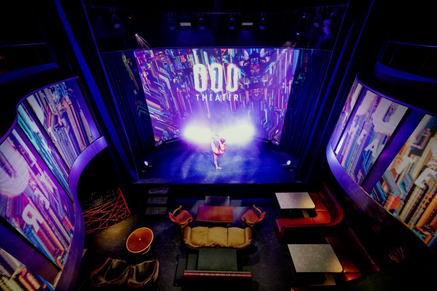 Interior of a double-height theatre space with mix-matched lounge seating