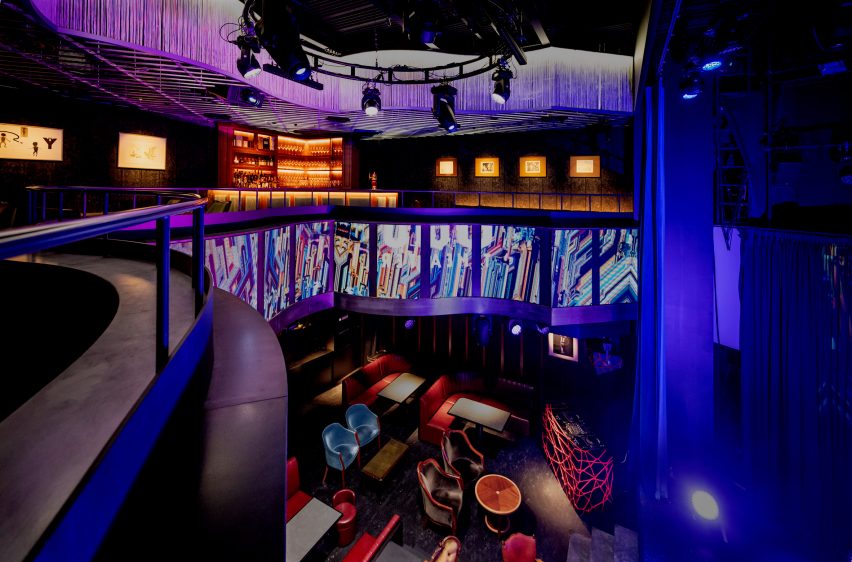 Interior of a double-height theatre space with mix-matched lounge seating
