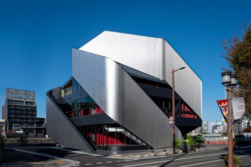 Exterior of a theatre building with sweeping steel panels by Clouds AO