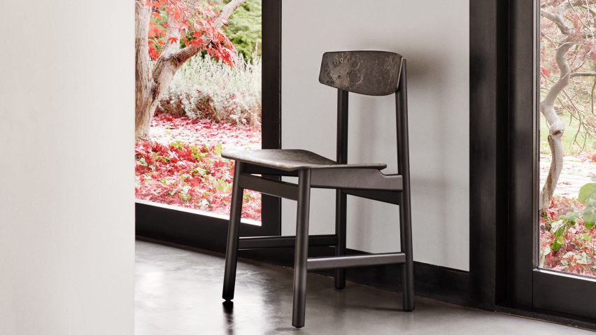 Dark neutral chair in between windows