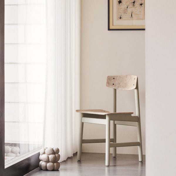 Neutral coloured chair in front of window