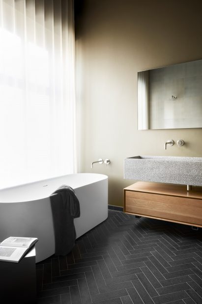 Photograph of bathroom with bath below long window