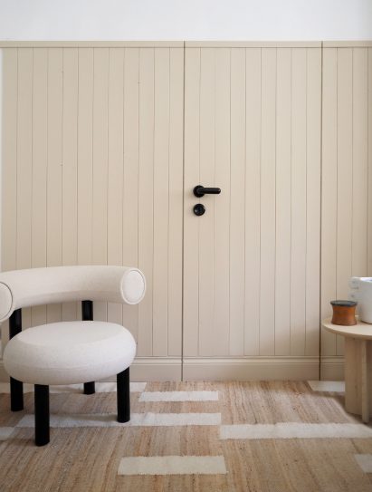 Neutral room with light wood clad door
