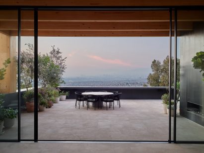 Roof terrace with black dining table and chairs