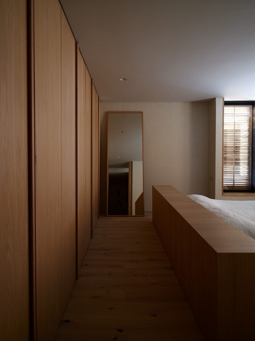 Bedroom with built-in timber wardrobes and full length mirror