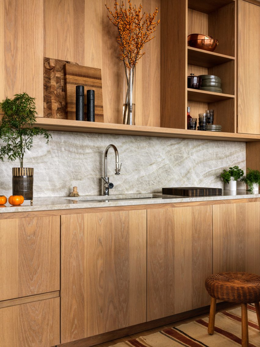 Kitchen with timber units and wall storage with grey splashback