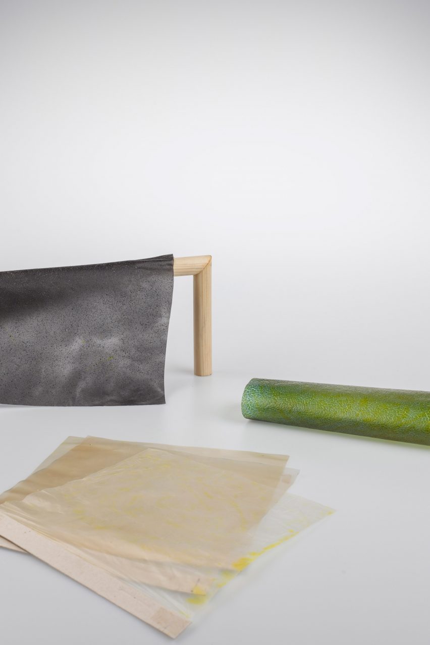 Rolls of fabric made from algae on plain backdrop