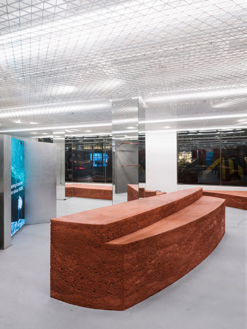 Shop interior with grey floor and rammed-earth displays
