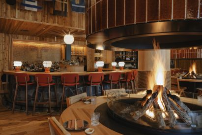Fire pit foregrounds a rounded bar behind