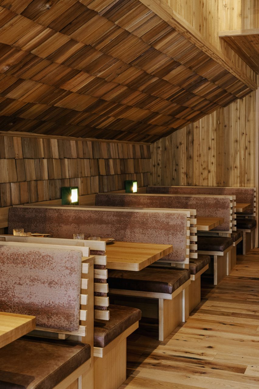 Booths beside angled shingle-covered walls