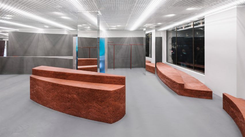 Shop interior with grey floor and rammed-earth islands