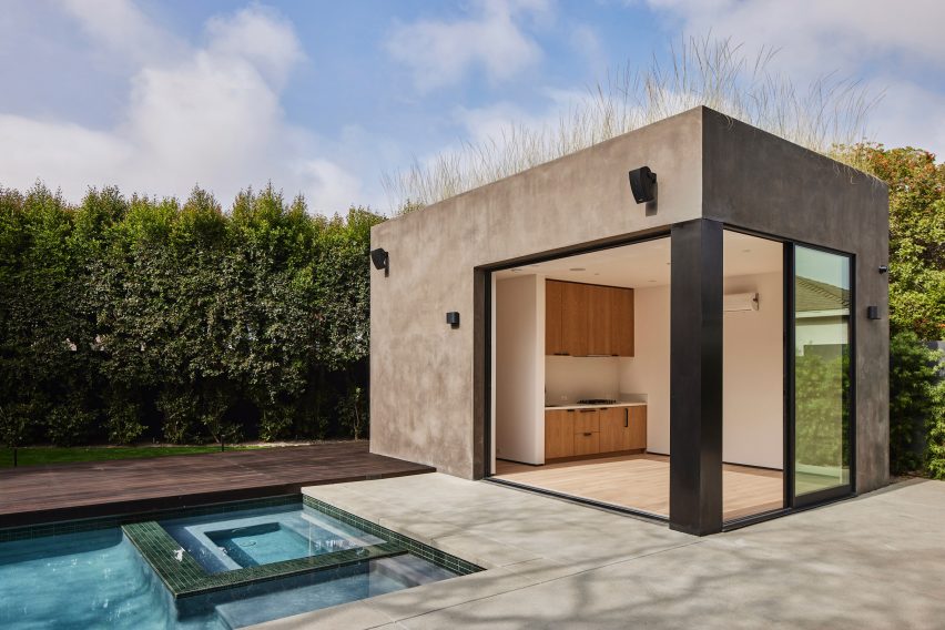 Rectangular stucco pool house by a residential swimming pool