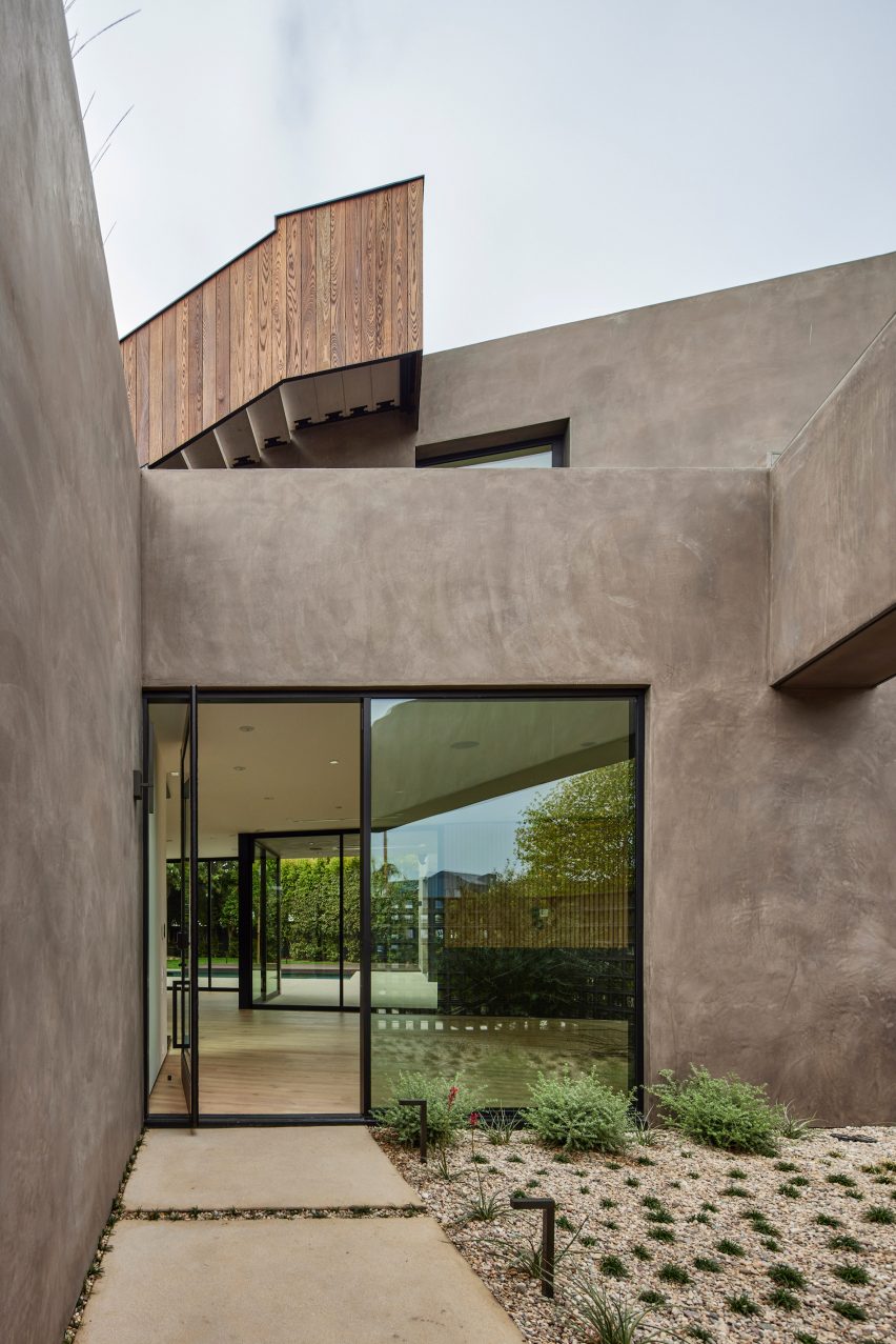 Roof terrace with sliding glass doors and stucco wall finish