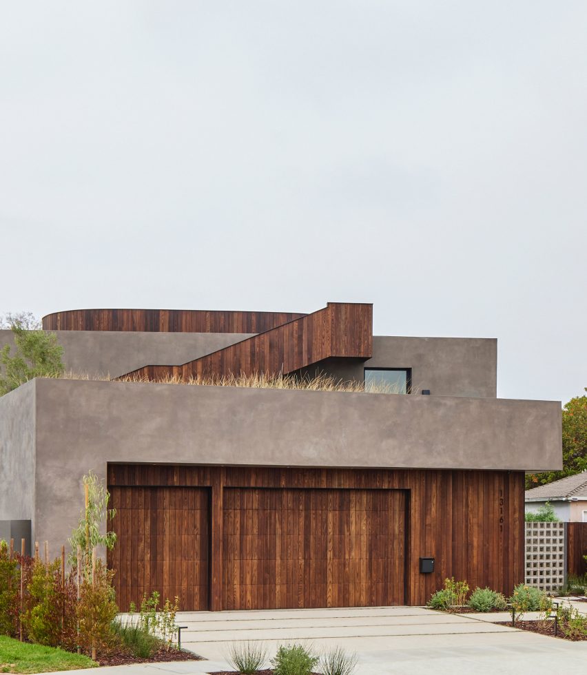 Concrete rectangular house with timber panelling on the ground floor and external staircase