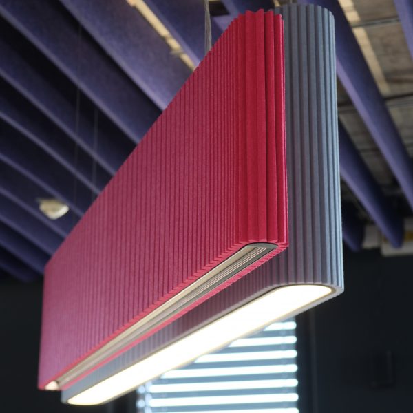 One pink and one blue pendant lamp with acoustic panelling