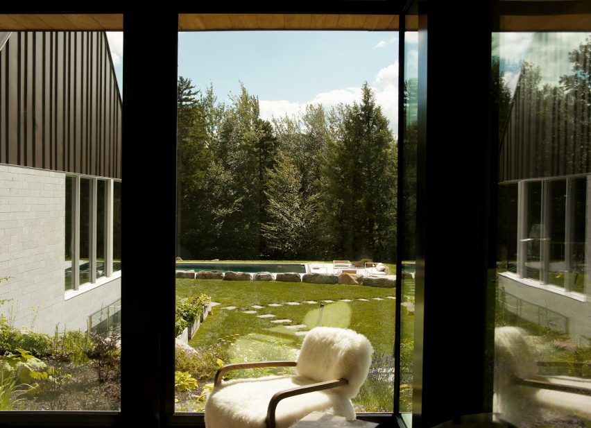 Windows looking out to a pond in a forest