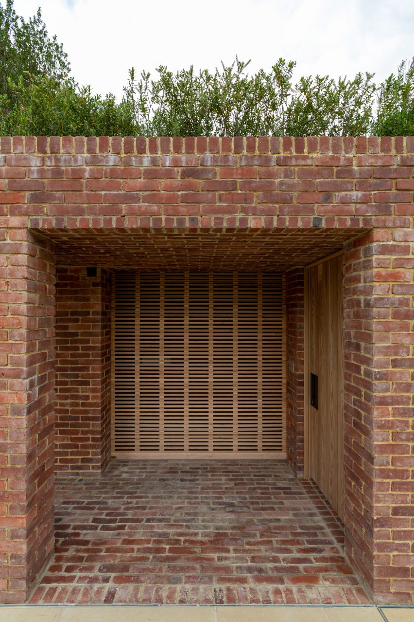 One-storey brick structure with a square opening topped with planting