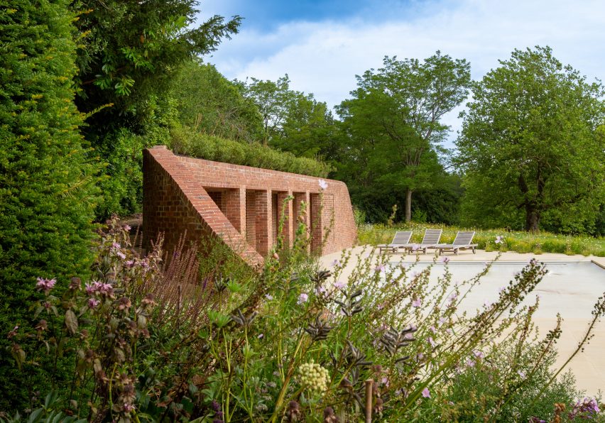 Brick curved pool house in the garden of a house in Kent