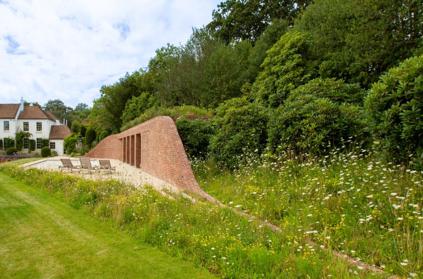 Brick curved pool house in the garden of a Georgian house in Kent