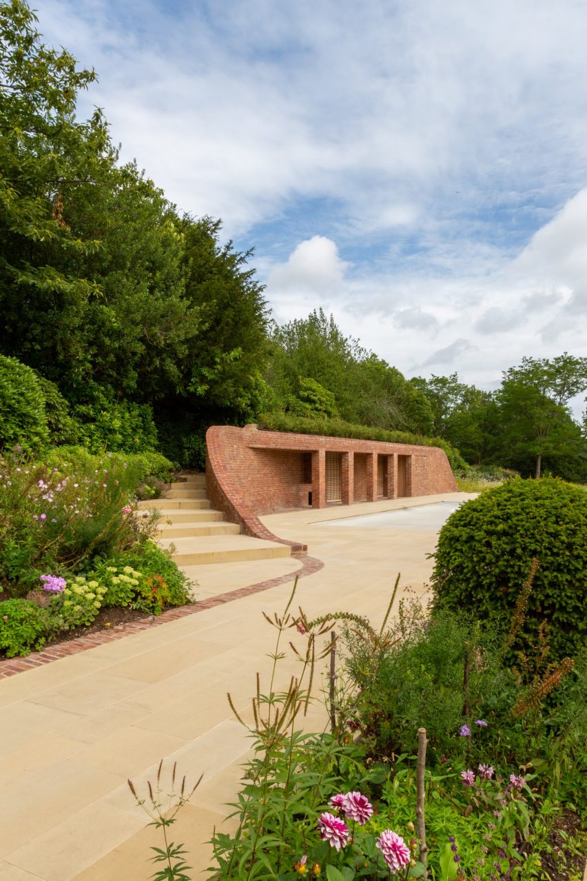 Brick pool house buried under a grass mound in the garden of a Kent home