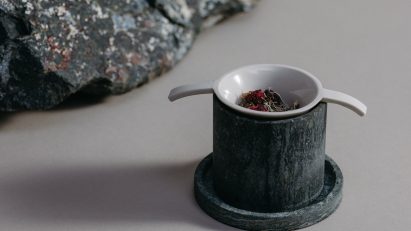 Stone cup beside rock
