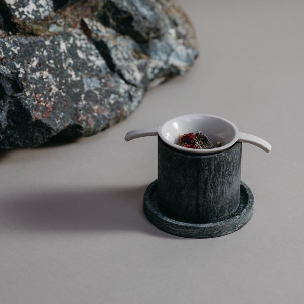 Stone cup beside rock