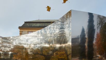 Mirrored curved structure in front of castle
