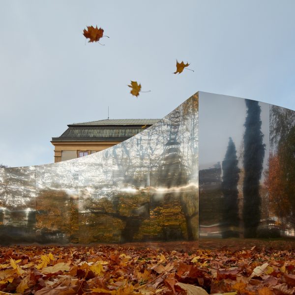 Mirrored curved structure in front of castle