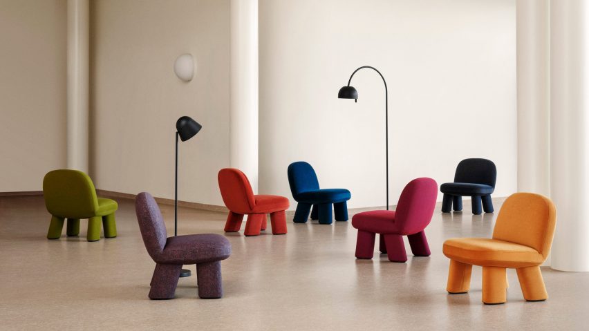 Seven coloured chairs in high-ceilinged interior