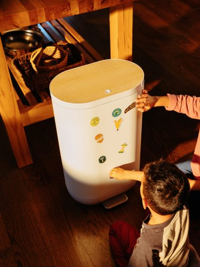 Boy putting stickers on a white Mill bin