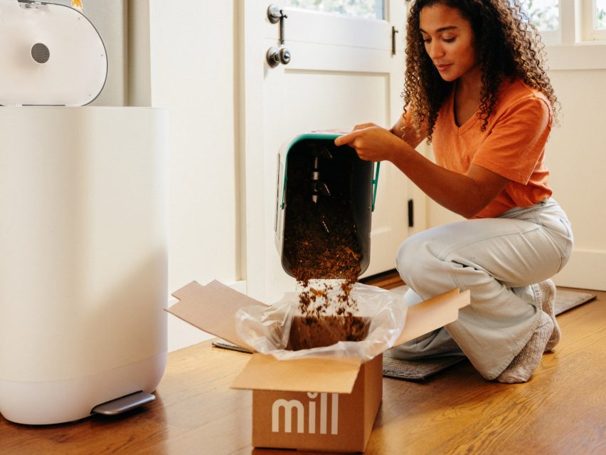 Photo of a woman tipping a tray of food grounds into a carboard box labelled Mill
