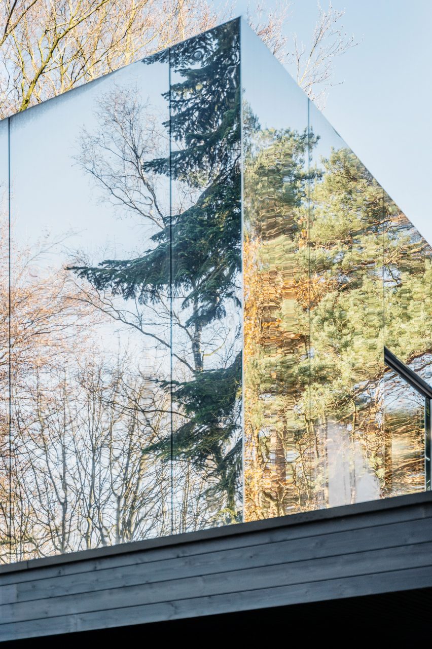 Mirror-clad structure reflecting the surrounding forest