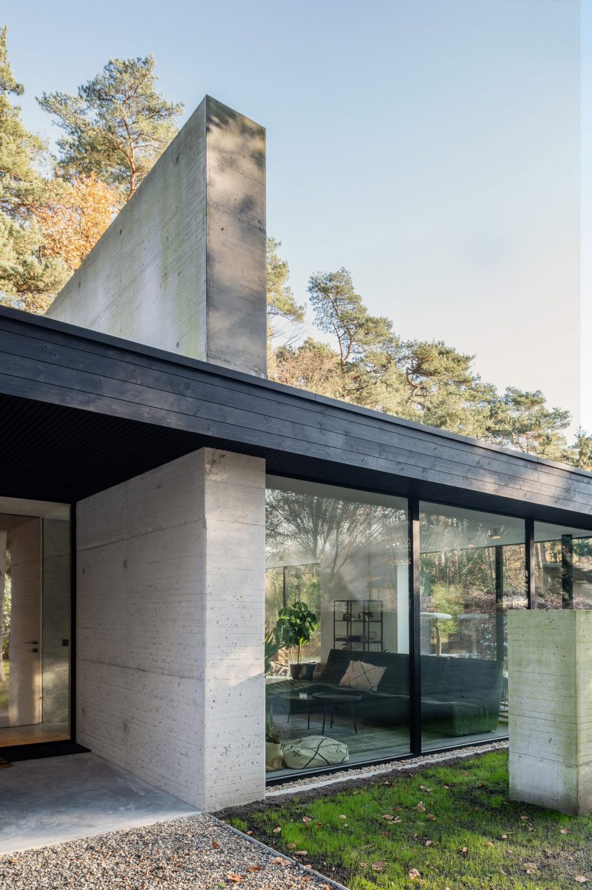 Exterior of the bottom level of a glazed home with concrete walls