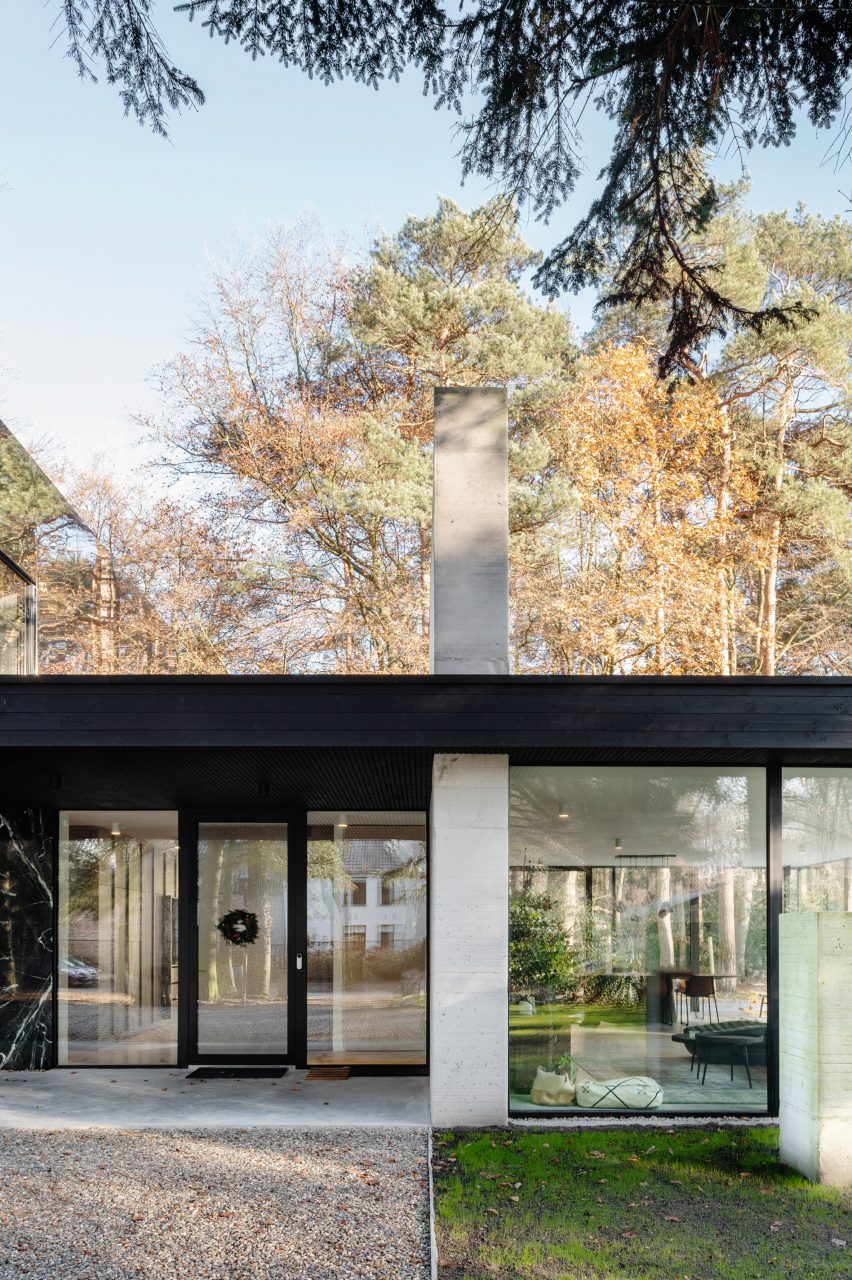 One-storey home in a forest with glass facade and concrete walls