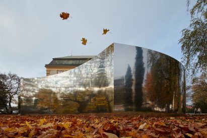 Mirrored curved structure in front of castle