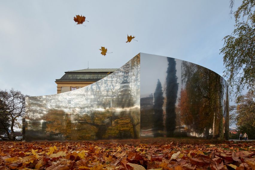 Mirrored curved structure in front of castle