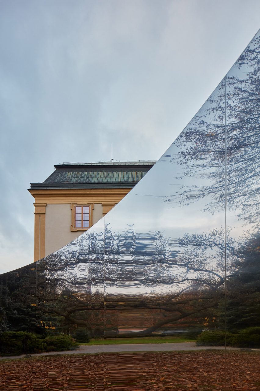 Mirrored curved structure in front of castle
