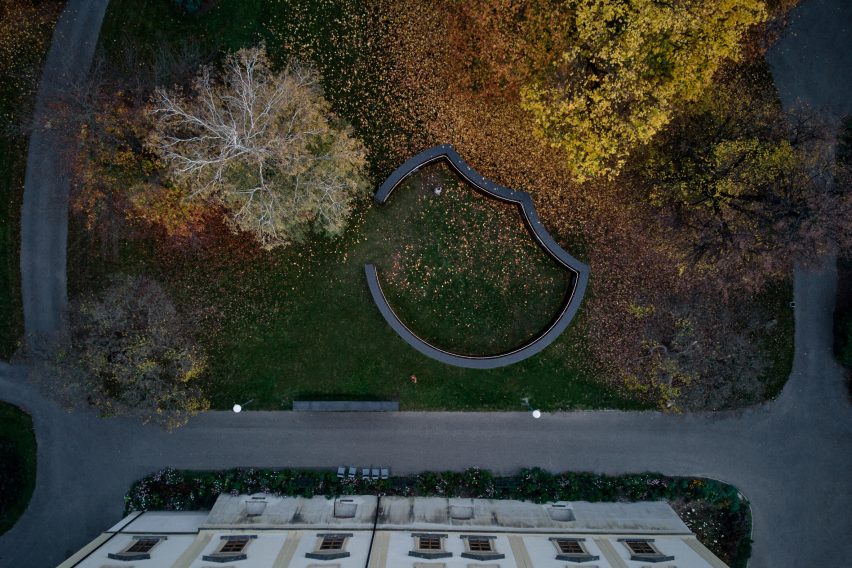 Aerial view of curved and straight installations in front of castle