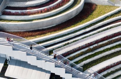 External staircase over stepped terraces filled with colourful planting