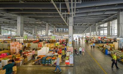 Open-air food market with tall ceilings
