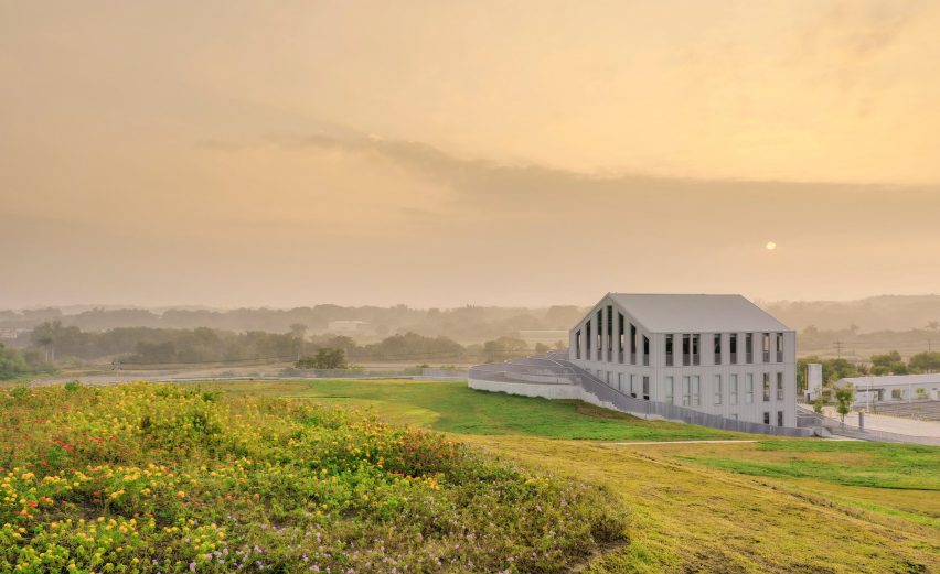 Curving grass roof and four-storey building overlooking the Tainan landscape