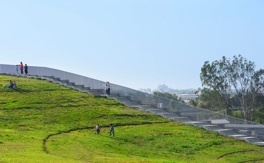 People walking on the undulating green roof of the Tainan food market by MVRDV