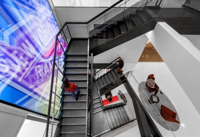 Feature staircase with brightly lit media wall