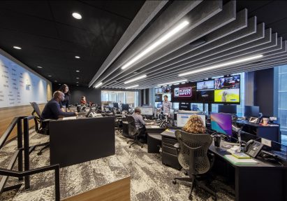 Screen with rooms and workers within NHL headquarters in New York