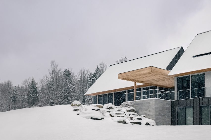Cabin home with outdoor space with timber roof on a snowy mountainside