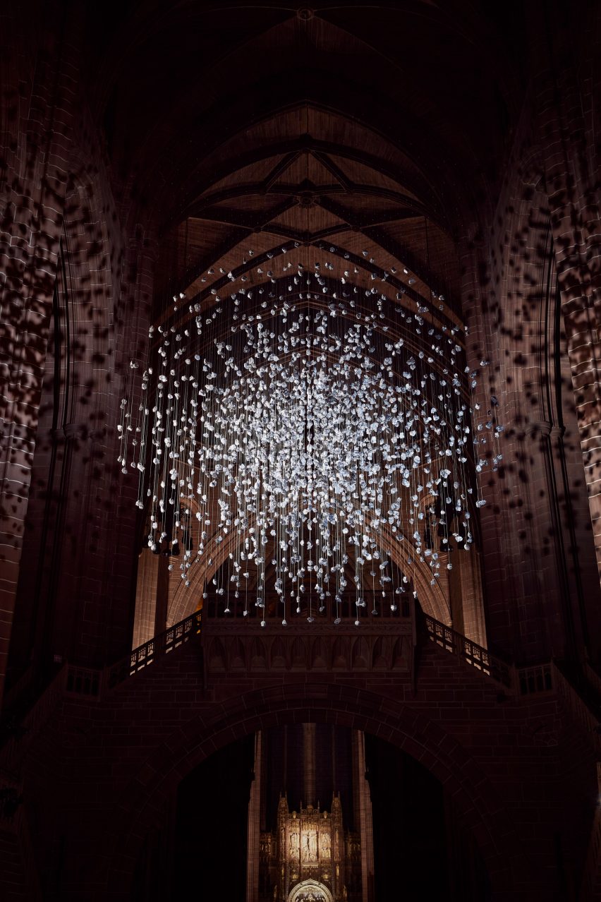 Spherical installation made up of suspended piece of coal illuminated inside a cathedral