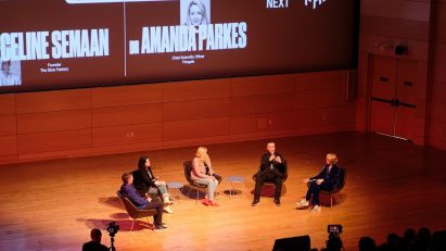 Five speakers sitting on stage during a talk at the Our Incredible Future Now talk