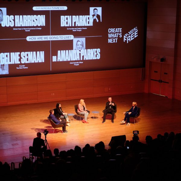 Five speakers sitting on stage during a talk at the Our Incredible Future Now talk
