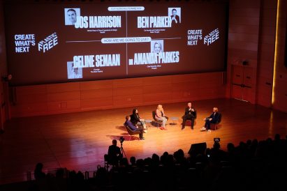 Five speakers sitting on stage during a talk at the Our Incredible Future Now talk